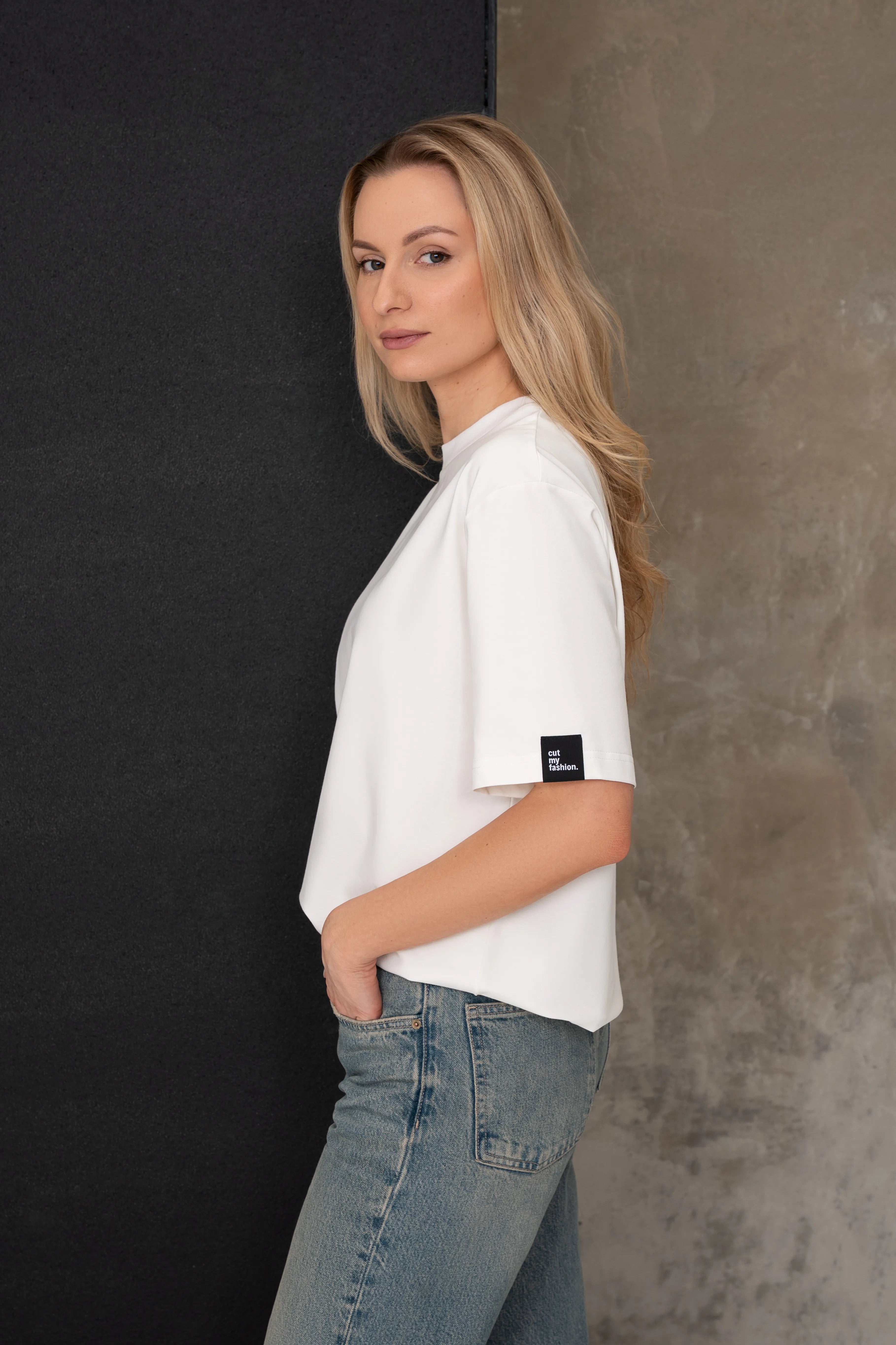 Medvilniniai oversized marškinėliai moterims pieno baltumo spalvos, šoninis vaizdas su etikete